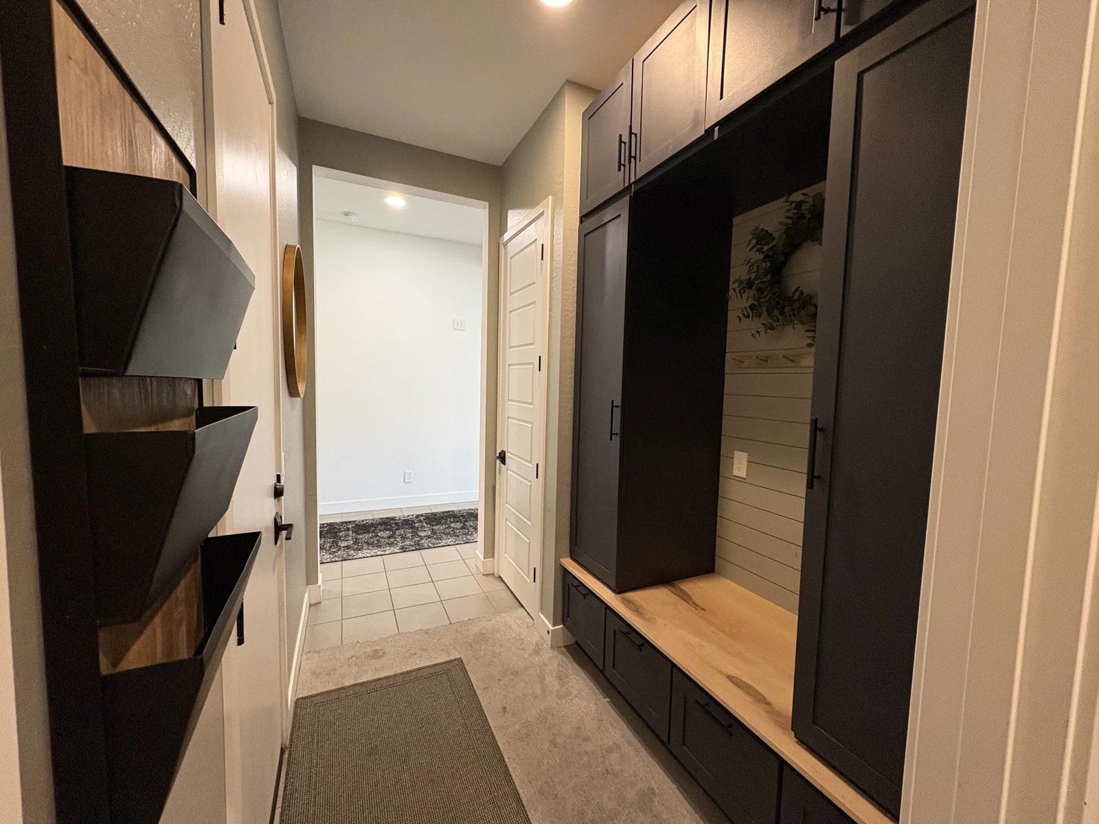 Dark custom entry built-in with natural wood bench