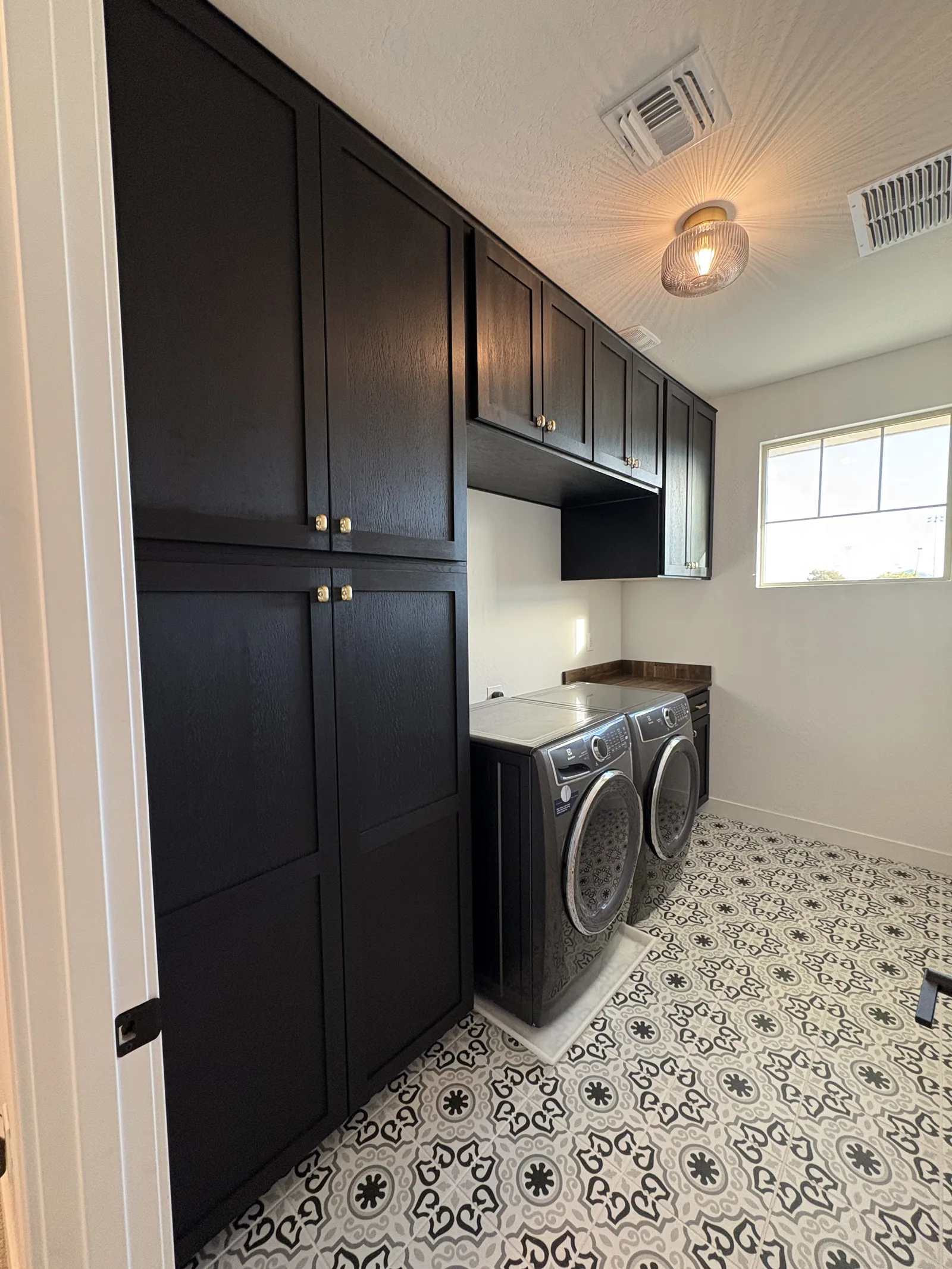 Dark custom laundry room built-in cabinetry