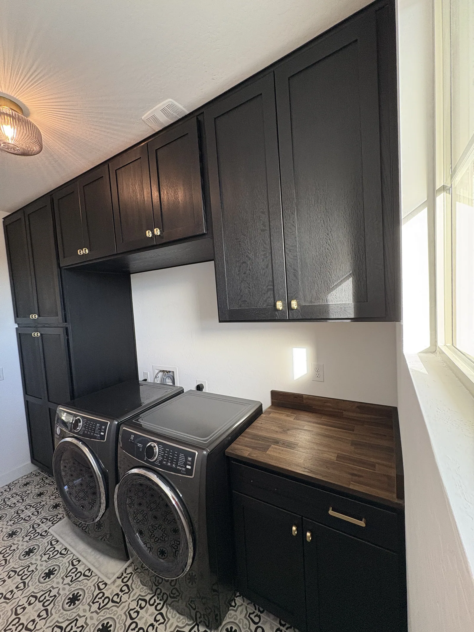 Close view of tall laundry storage and countertop