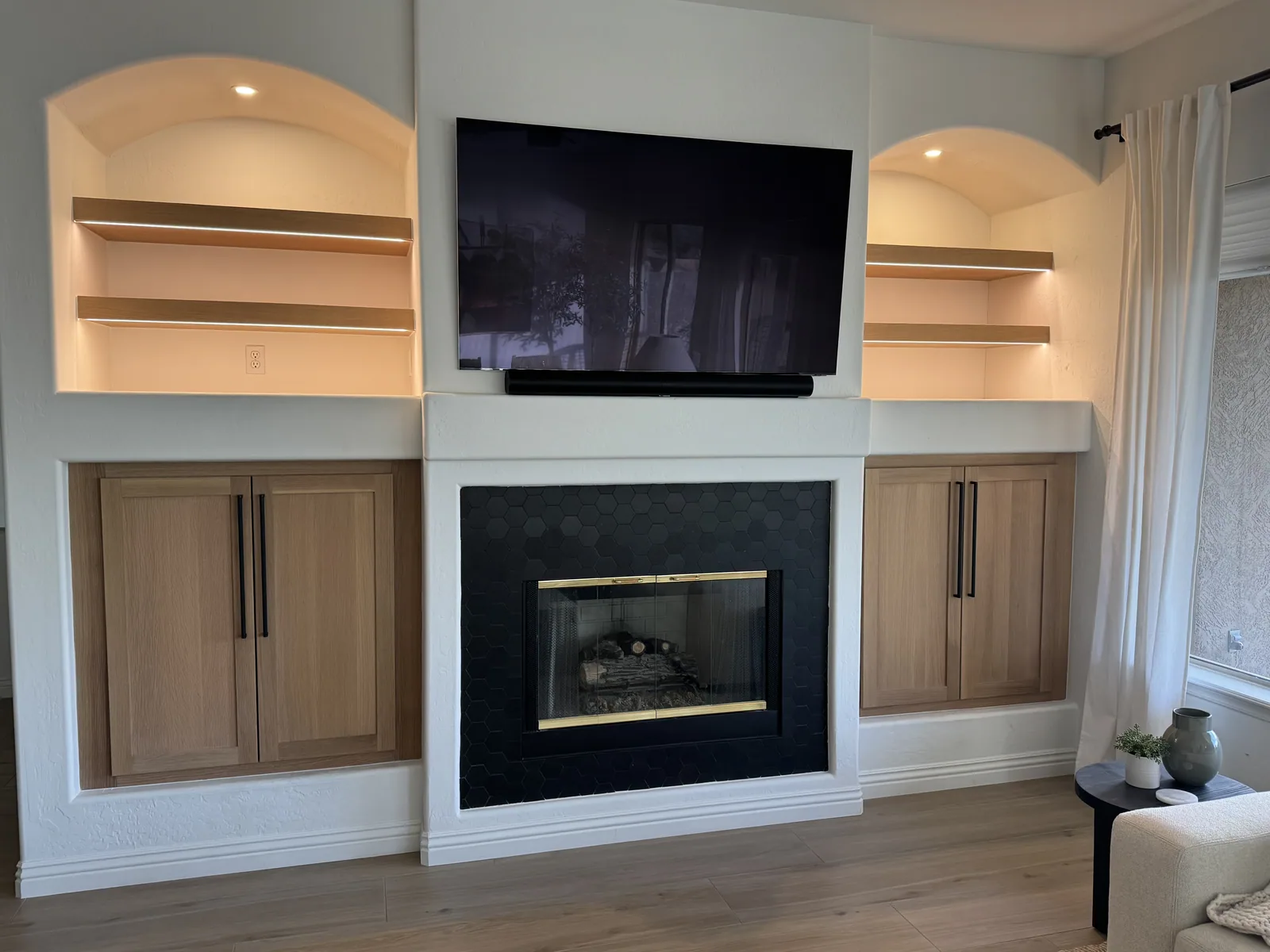 Custom fireplace built-in with illuminated shelves