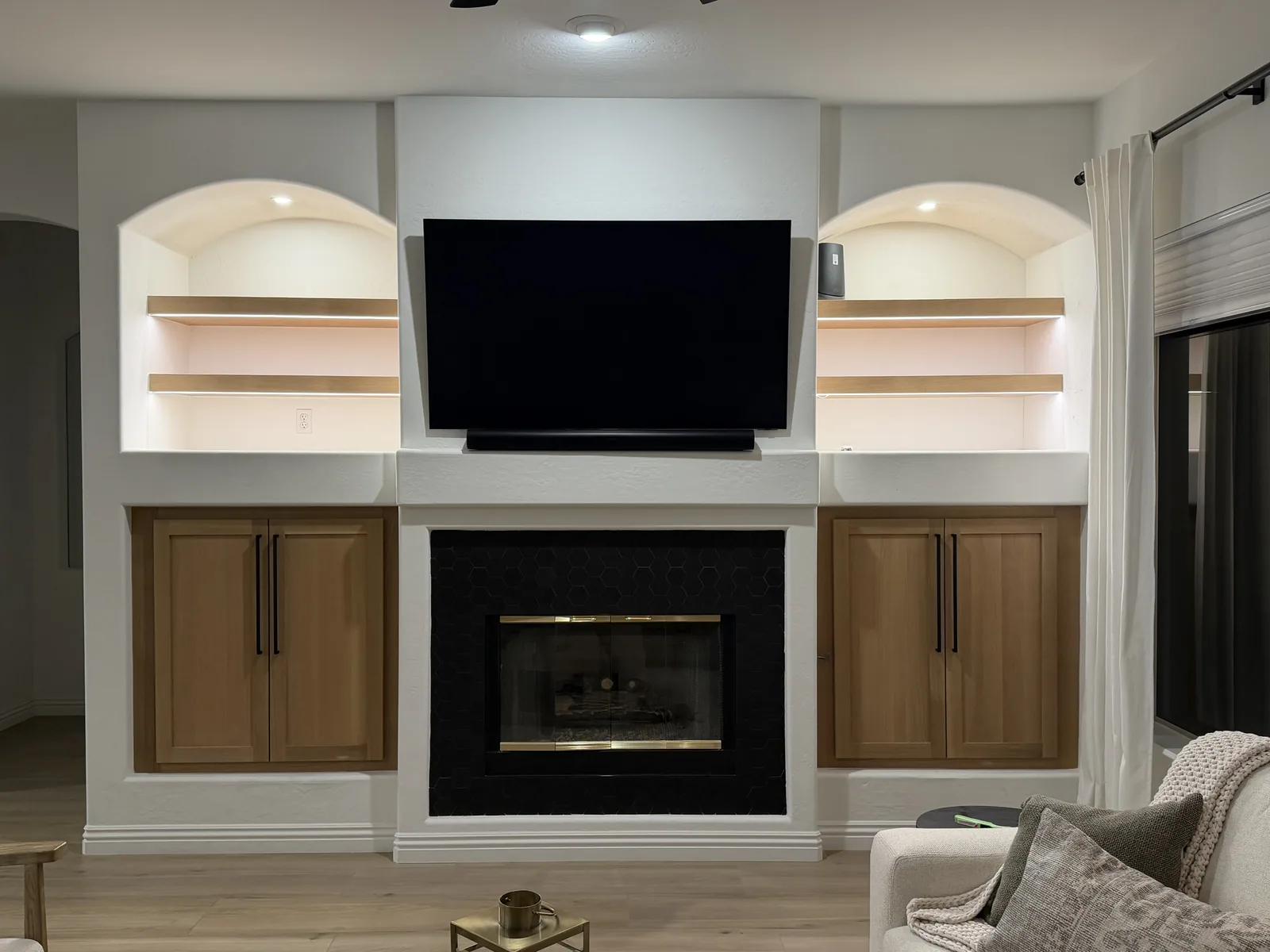 Symmetrical fireplace wall with custom built-in cabinetry