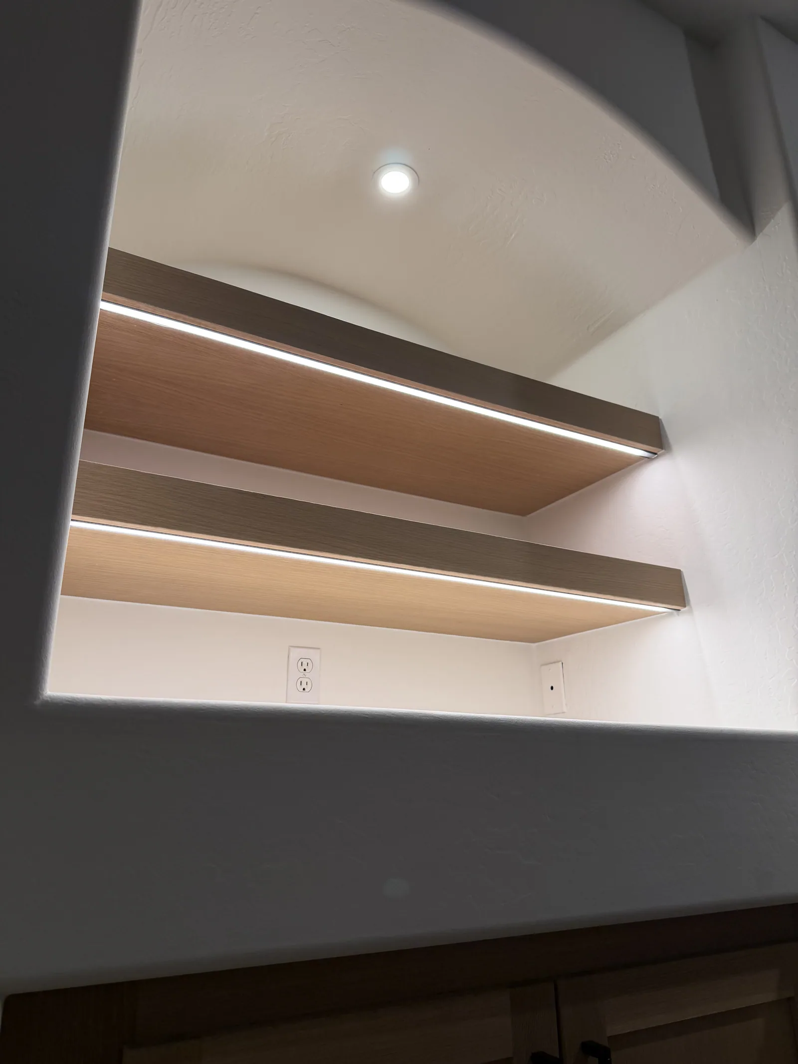 Close view of illuminated wood floating shelves