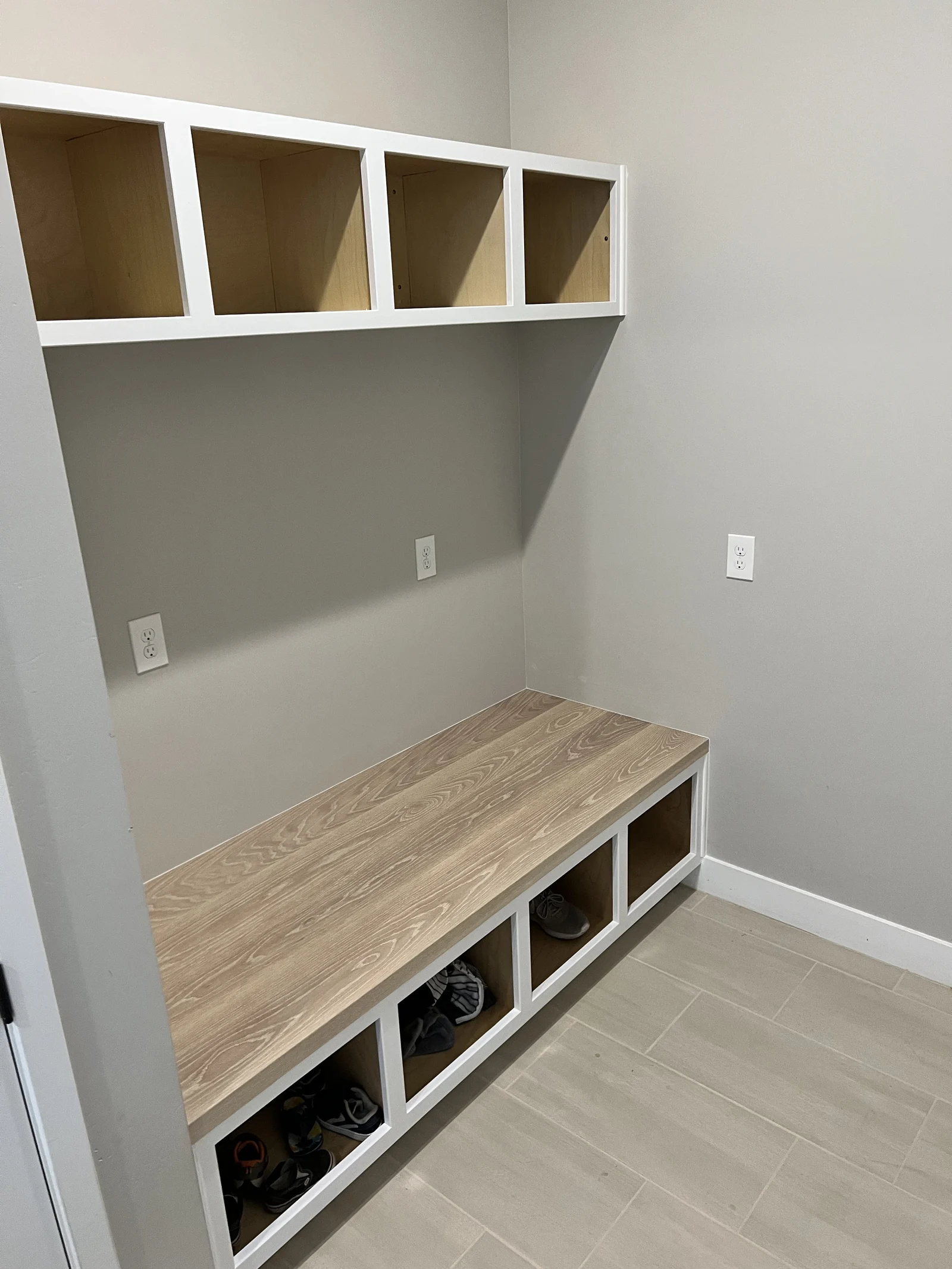 Full-height mudroom built-in with upper cubbies and bench
