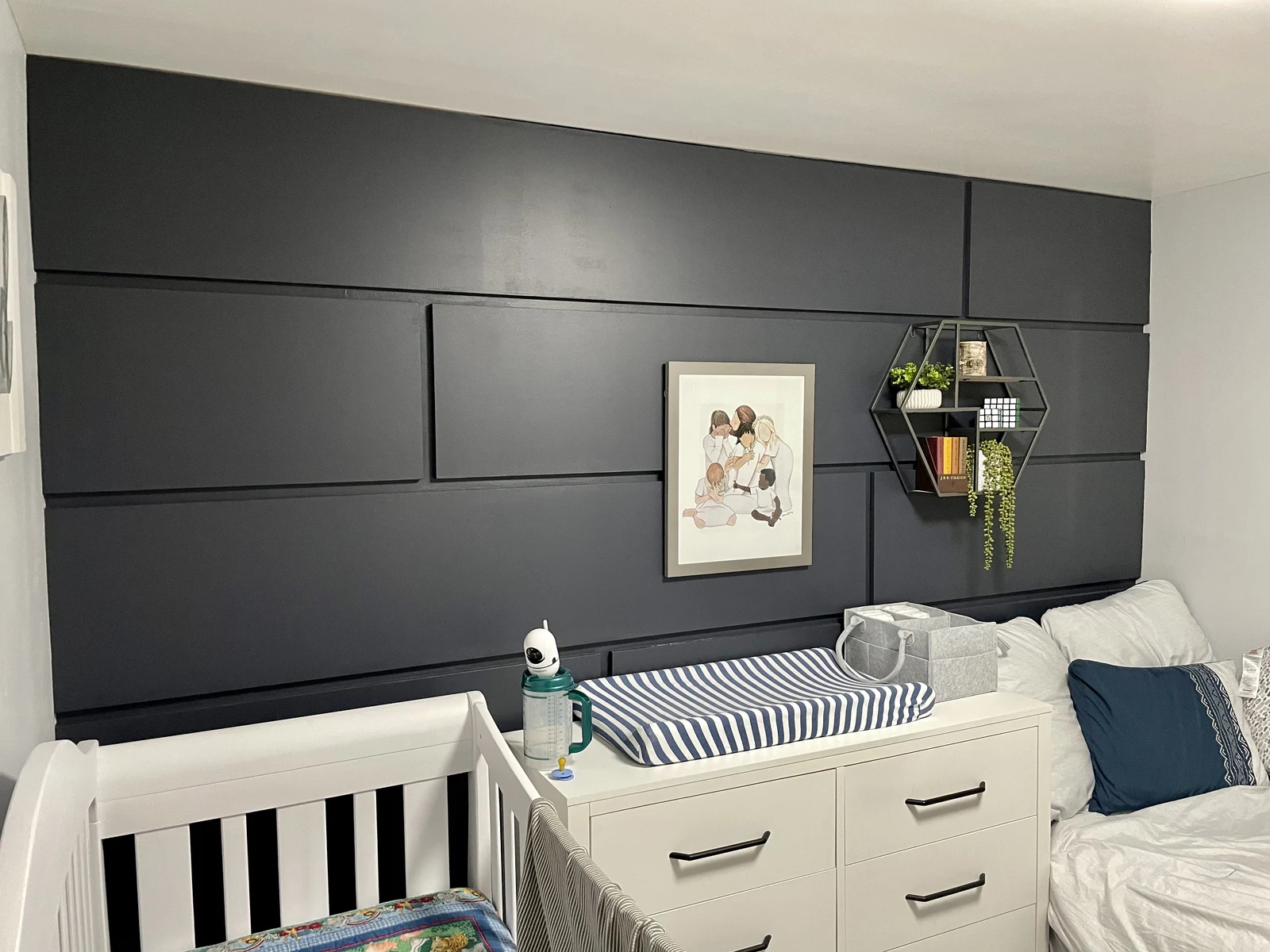 Dark geometric accent wall in a residential nursery