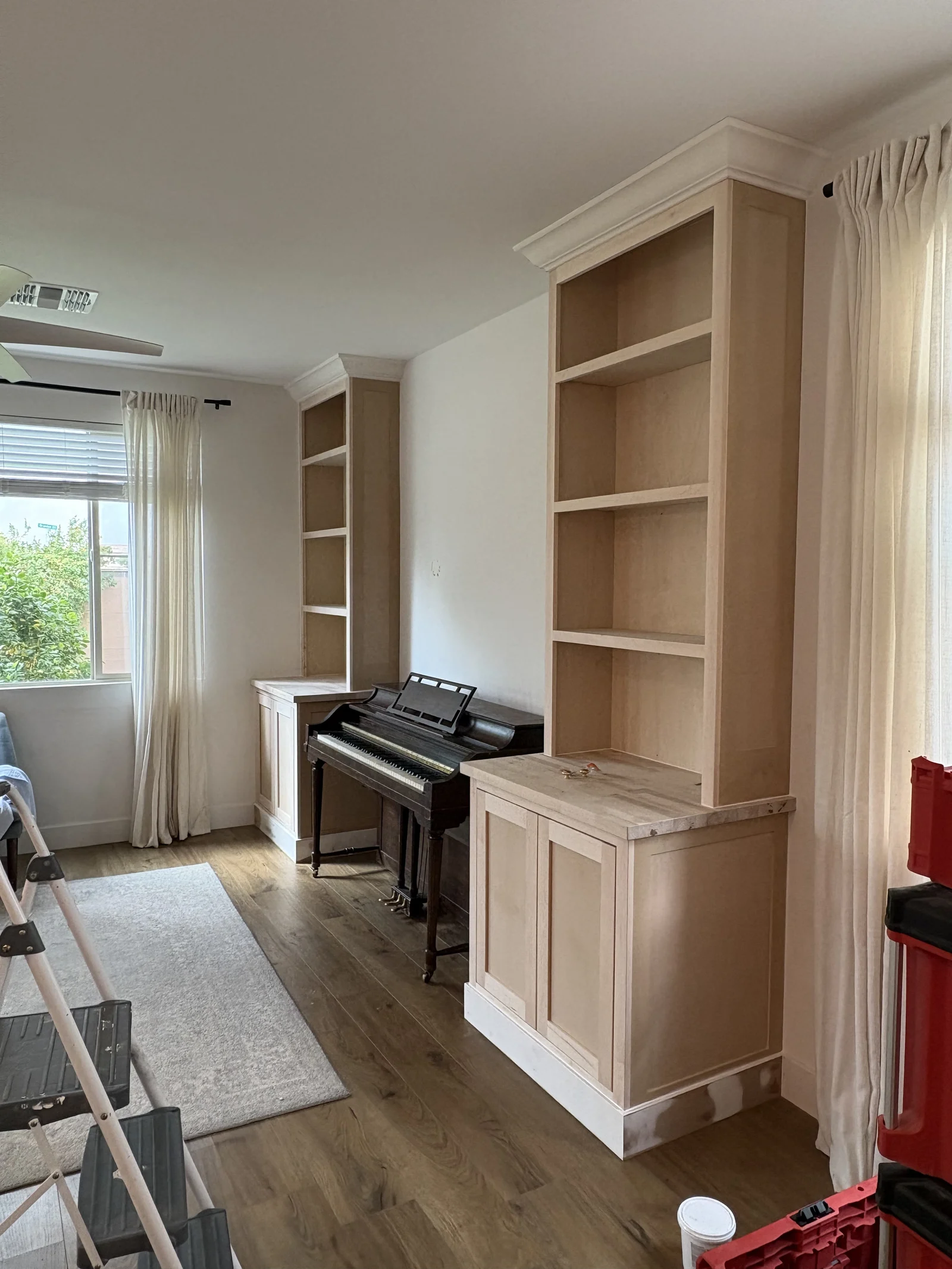 Natural wood built-ins framing a piano