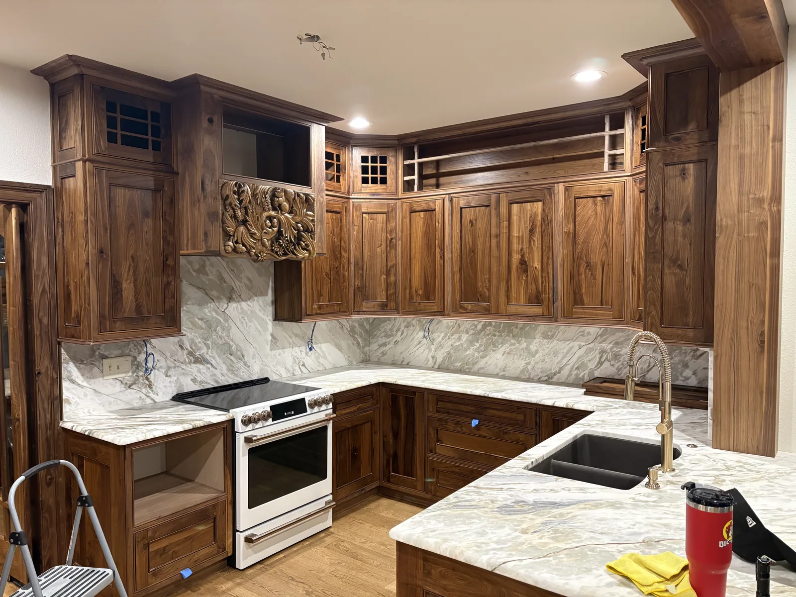 Custom walnut kitchen cabinetry with stone countertops