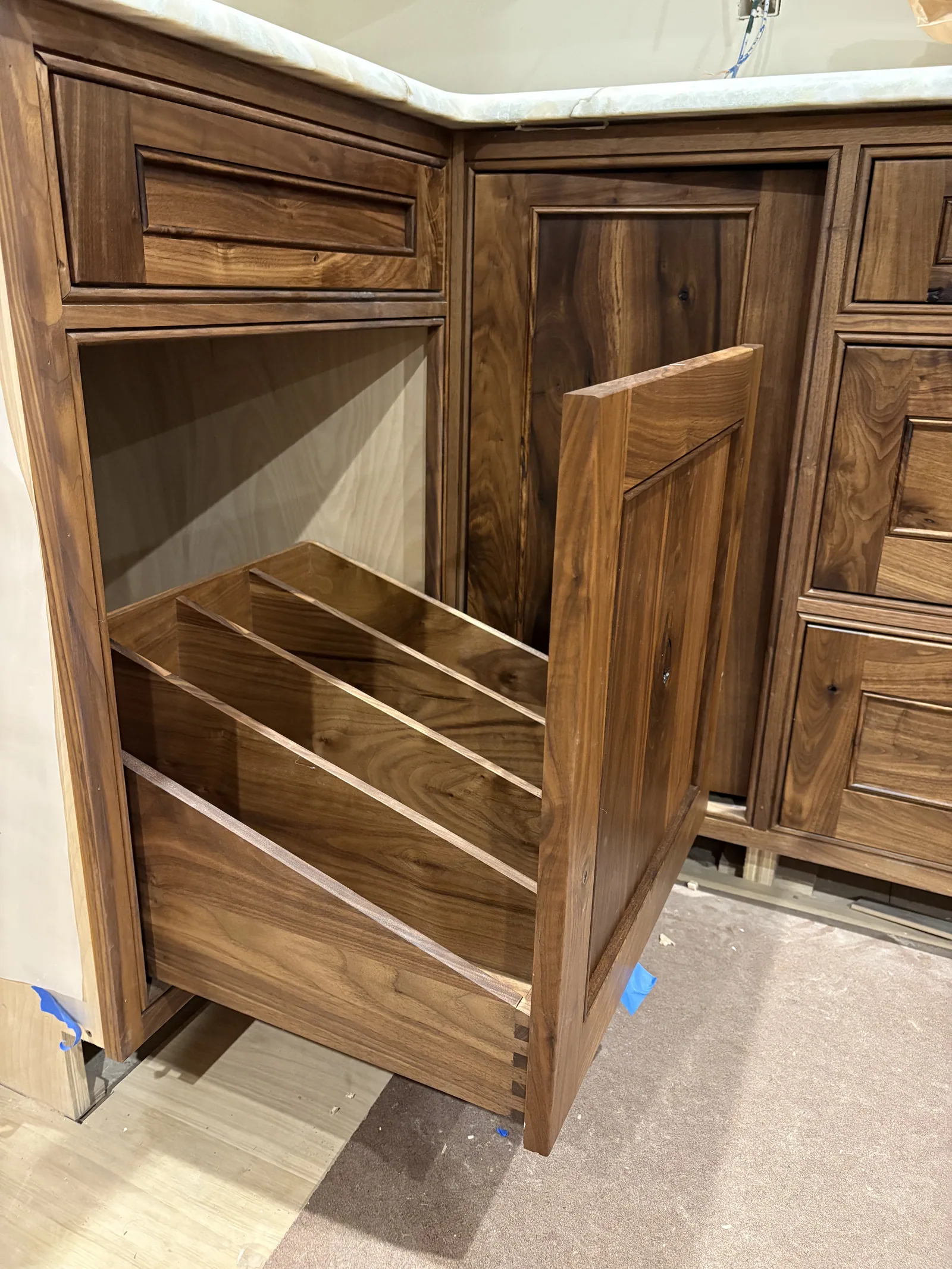 Custom pull-out storage inside walnut cabinetry